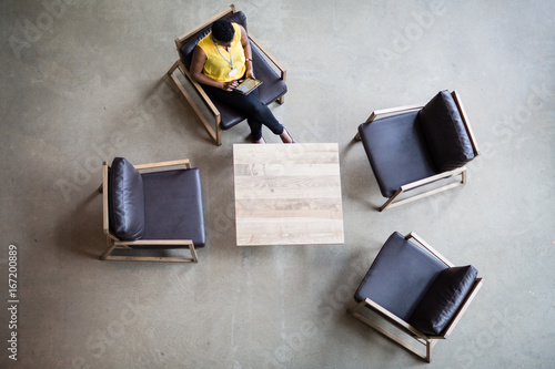 Overhead shot of businesswoman working on digital tablet photo