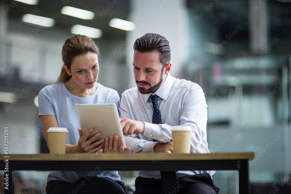Colleagues using a digital tablet in a meeting