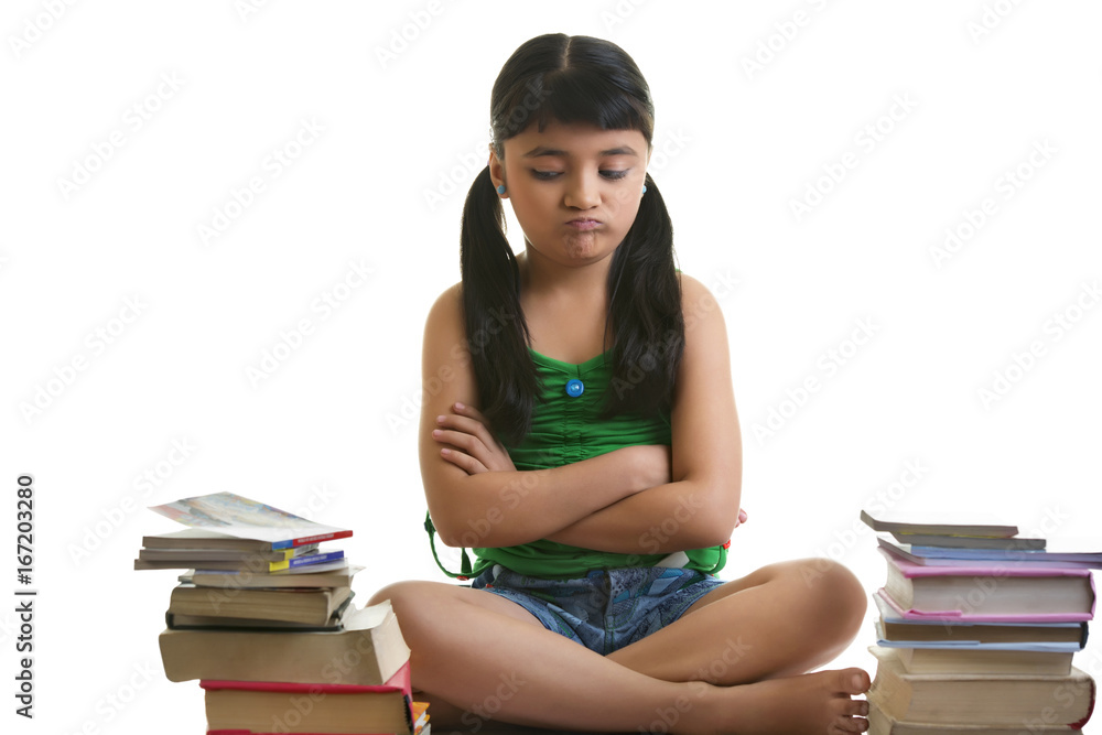 Girl sitting with a pile of books Girl sitting with a pile of books