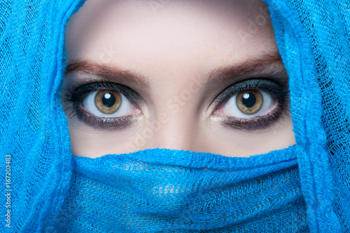 Beautiful female eyes looking above her veil