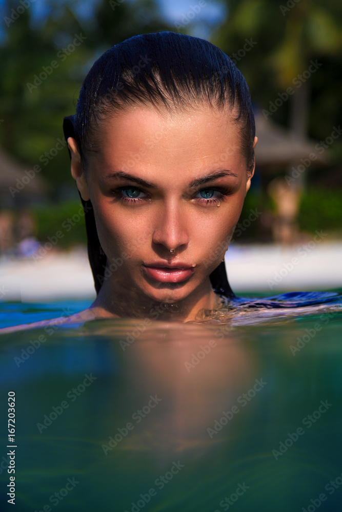 Girl in water closeup portrait