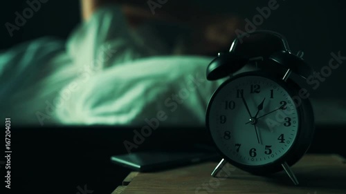 Restless man at night in bed trying to fall asleep