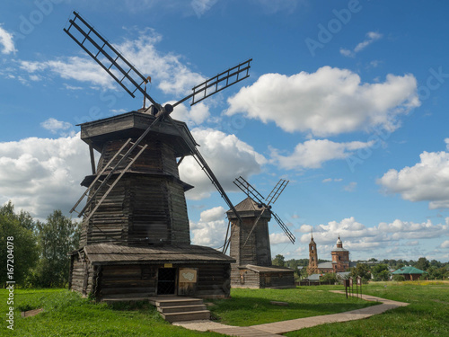 Old wooden windmill in Suzdal, Russia. The windmill's blades act like a rotating fan which pushes the rod attached to it to the direction the wind is blowing.  © ikmerc