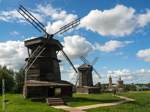 Old wooden windmill in Suzdal, Russia. The windmill's blades act like a rotating fan which pushes the rod attached to it to the direction the wind is blowing. 