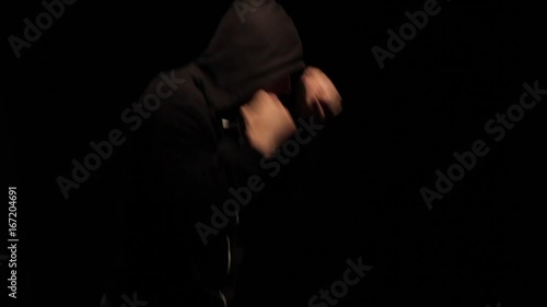 Boxer Throwing Punches in the dark photo