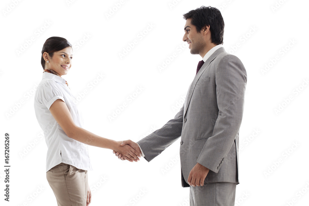 Young business people shaking hands over white background Young business people shaking hands over white background