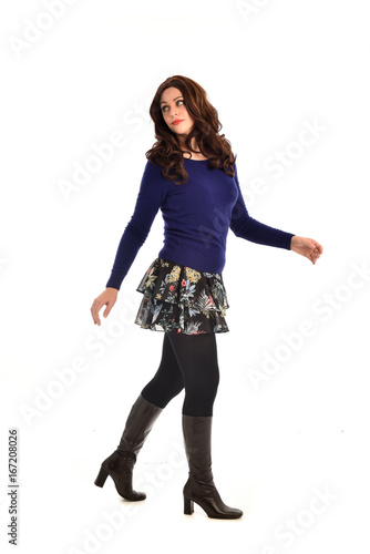 Full length portrait of a brunette girl wearing casual modern clothes. standing pose, isolated against white background