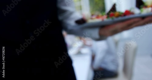 Mid section of waiter holding food tray photo