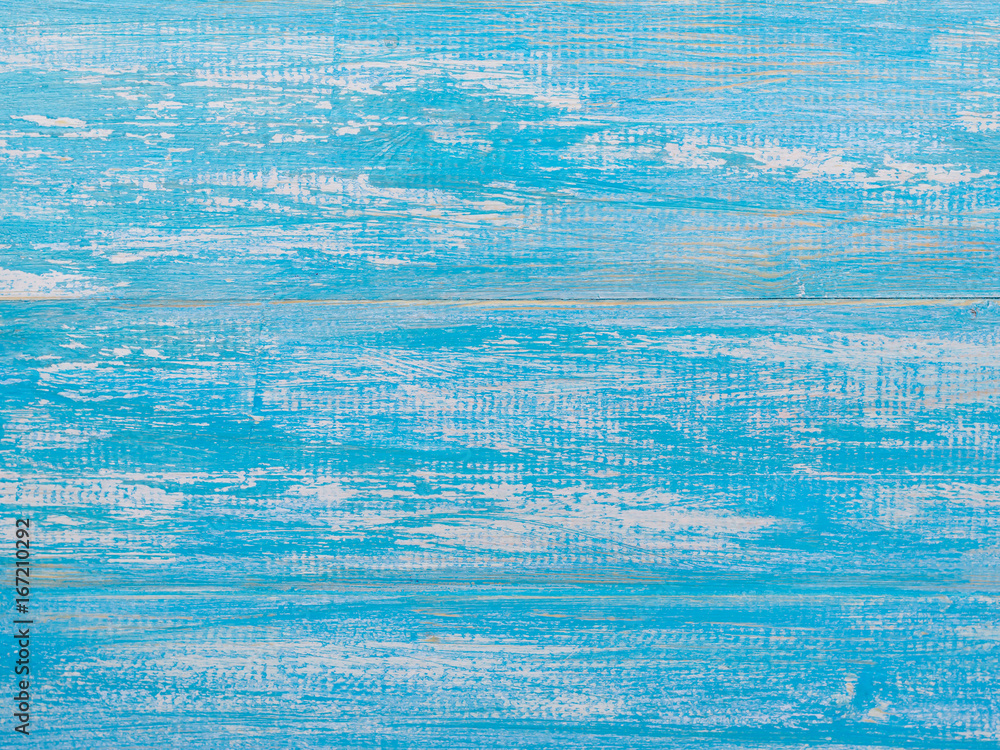 Naklejka premium Blue background of wooden boards unevenly colored paint.