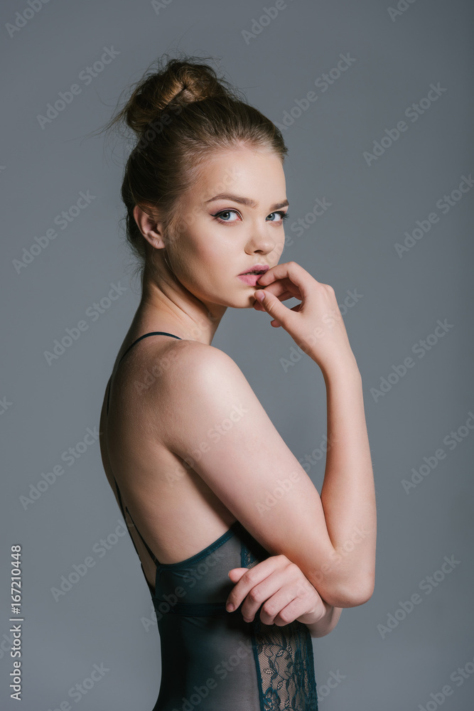 attractive young woman with slim body posing in lace underwear, isolated on grey attractive young woman with slim body posing in lace underwear, isolated on grey
