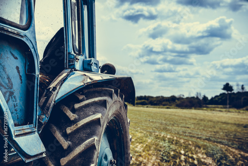 Old tractor in the field photo