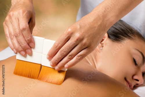 Wallpaper Mural Therapist doing treatment on female back with set of brushes. Torontodigital.ca