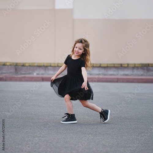little girl dancing on the street