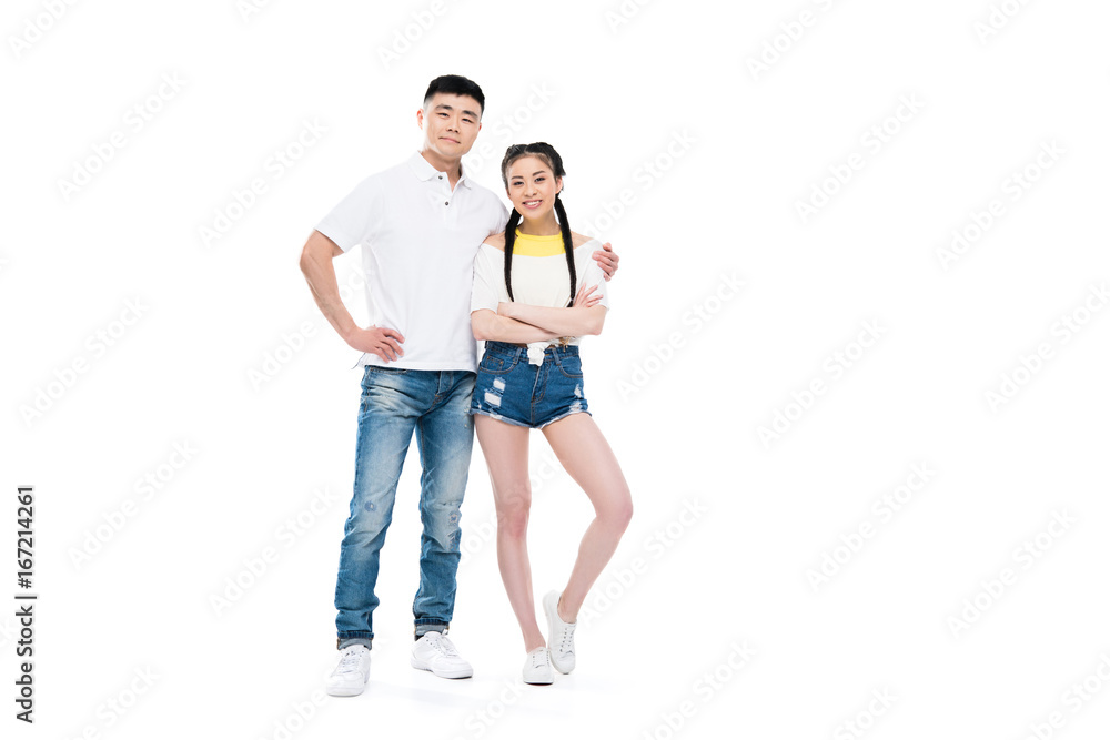 happy young asian couple standing embracing and smiling at camera isolated on white happy young asian couple standing embracing and smiling at camera isolated on white