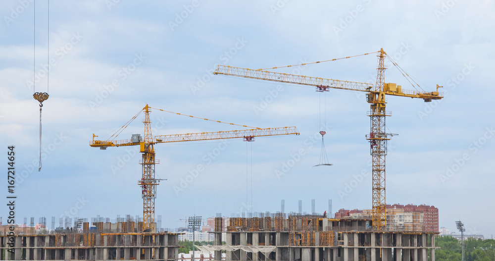 Tower cranes on a background of sky