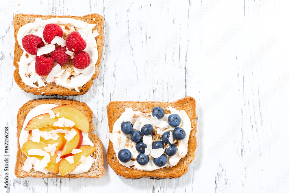 sweet toast with different toppings on white wooden table