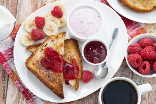 sweet toasts with fresh raspberry  jam and yoghurt for breakfast  top view