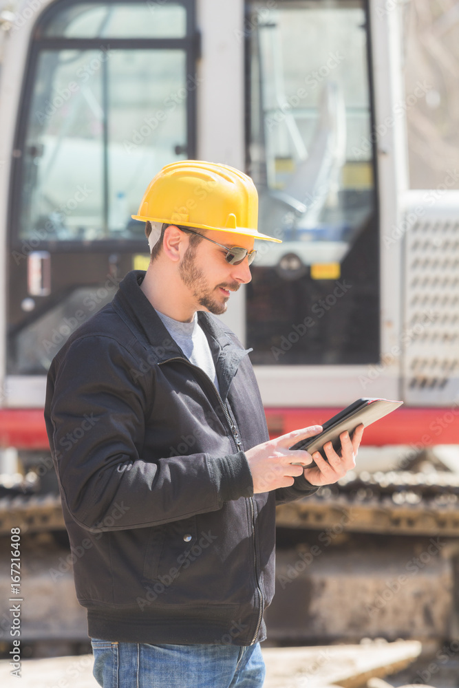 Real and ordinary construction worker using tablet on his job. Real and ordinary construction worker using tablet on his job.
