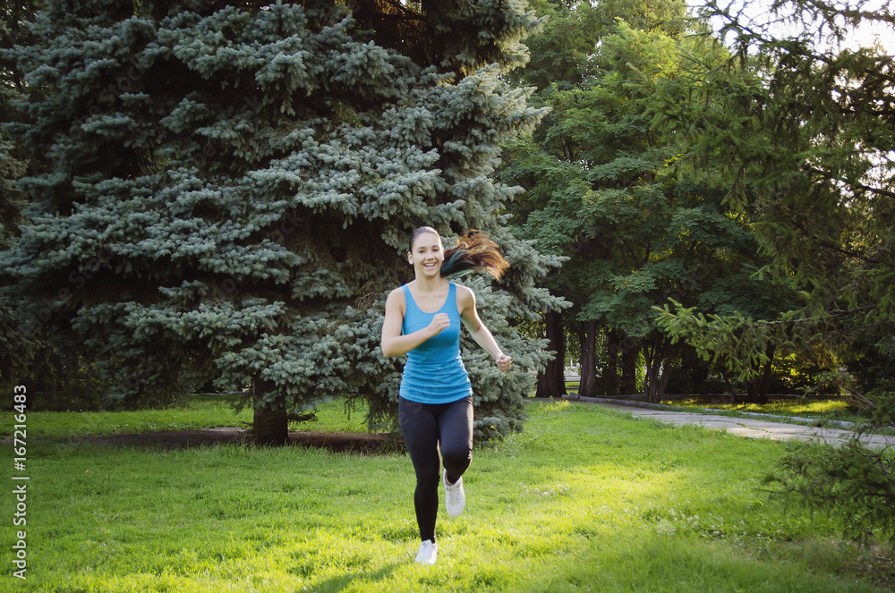 Girl is engaged in fitness in the park, doing exercises. Training on the street in the summer morning. Concept sport healthy lifestyle. Girl is engaged in fitness in the park, doing exercises. Training on the street in the summer morning. Concept sport healthy lifestyle.