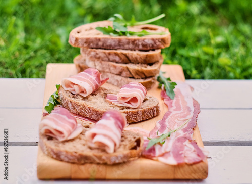 Bread with gourmet meat on a wooden desk.