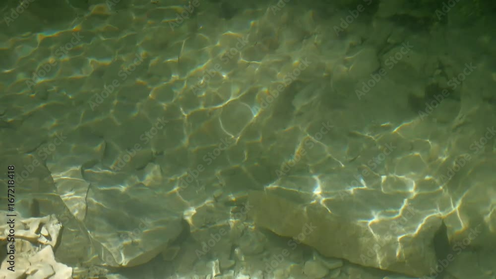 Large stones fragments of rock in water of mountain lake water. beautiful nature Large stones fragments of rock in water of mountain lake water. beautiful nature