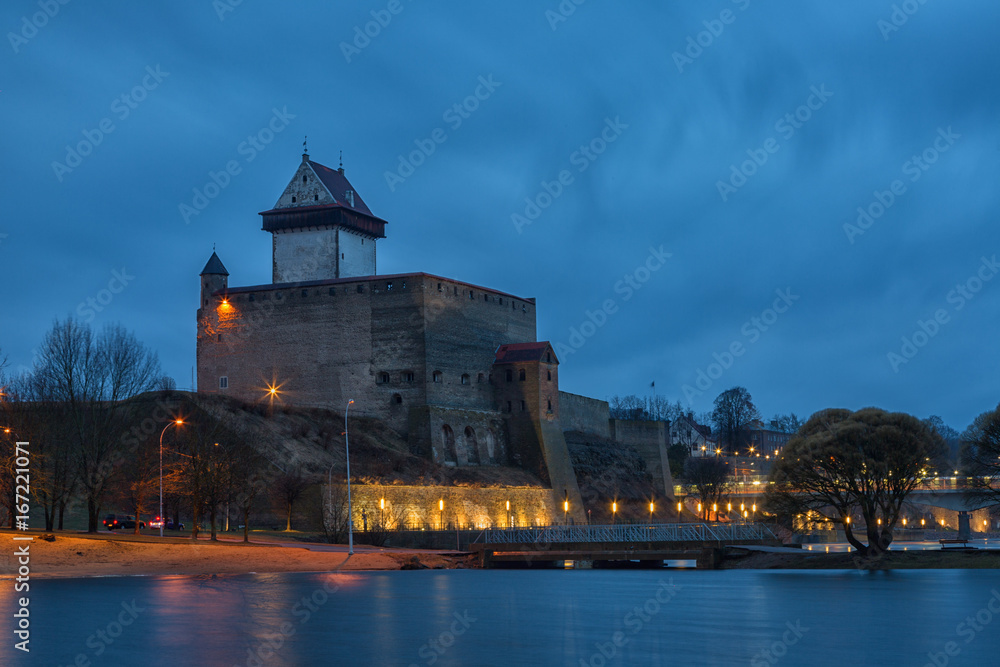 View of Narva Castle with tall Herman's tower in night. Estonia