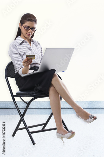 Secretary with a credit card and laptop 