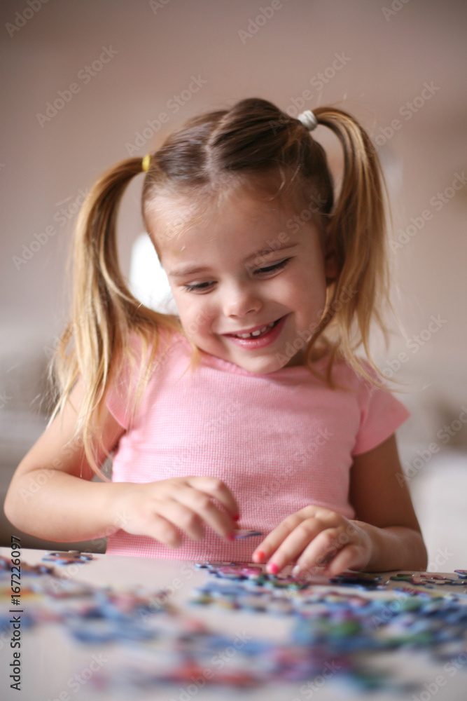 Girl playing puzzle.