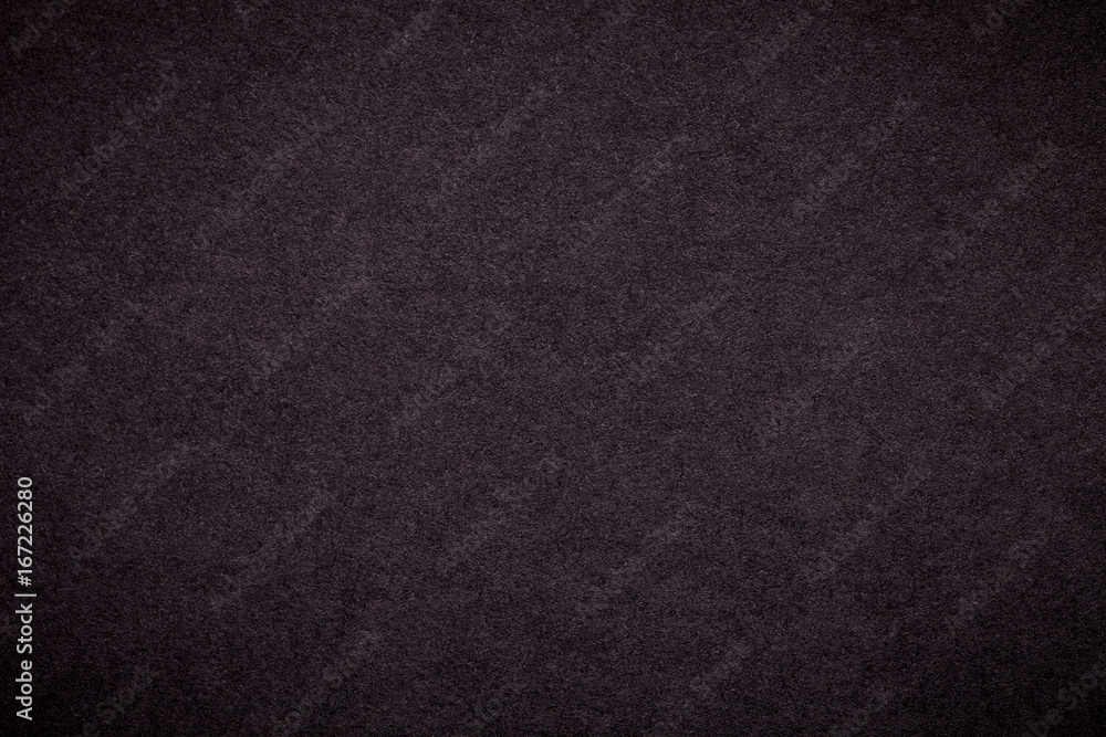 Texture of old dark brown paper background, closeup. Structure of dense black cardboard