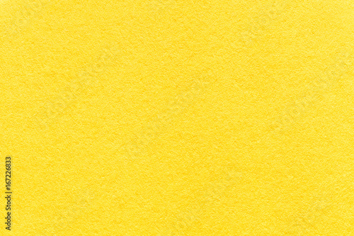 Texture of old light yellow paper background, closeup. Structure of dense lemon cardboard