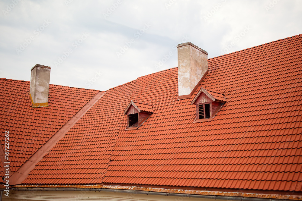 Retro red tile roof of old house.