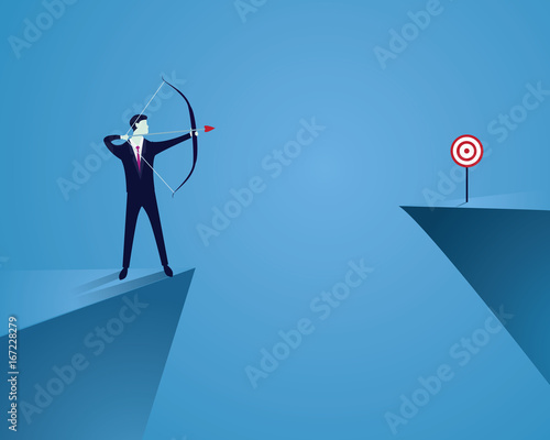 Businessman focus to hit target with bow and arrow