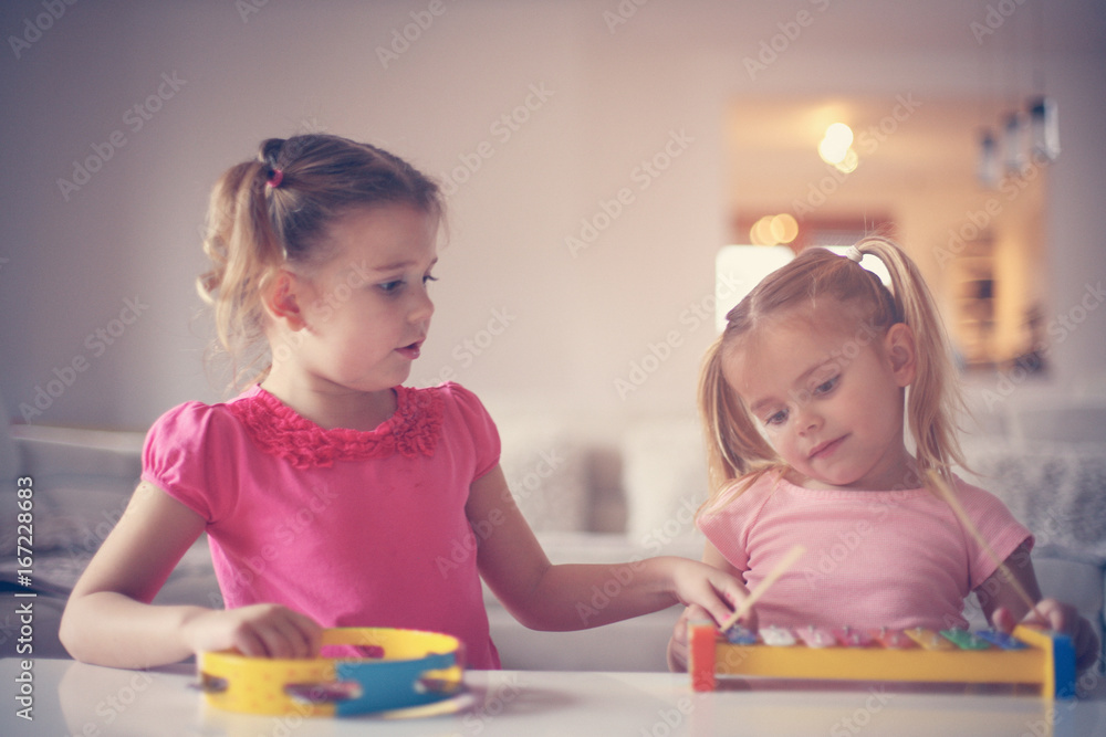 Fototapeta premium Two little girl at music school.