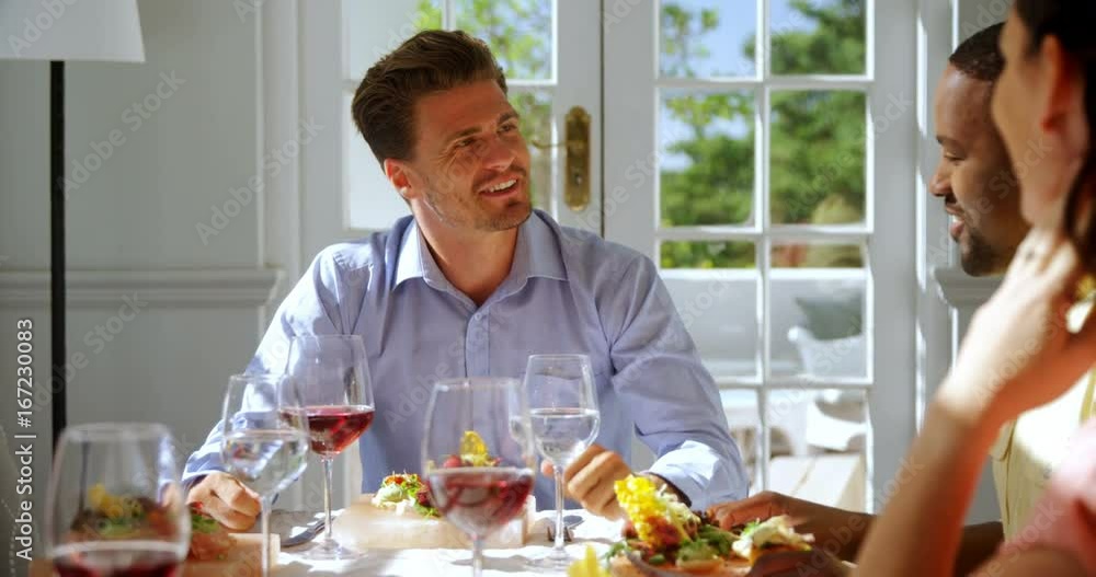 Group of friends interacting while having meal Group of friends interacting while having meal