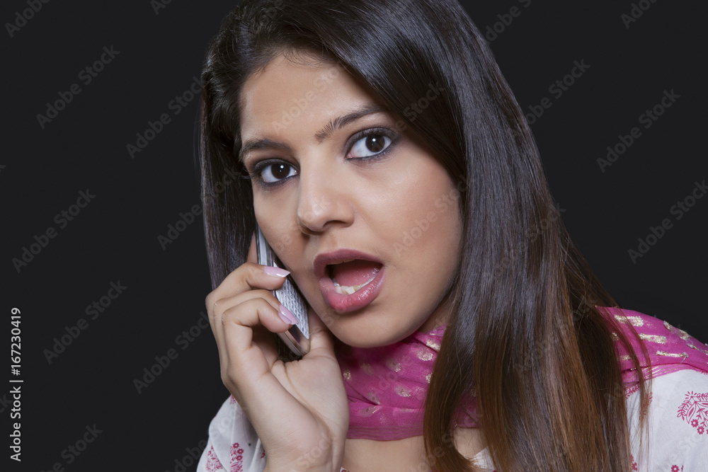 Young woman talking on her mobile phone Young woman talking on her mobile phone