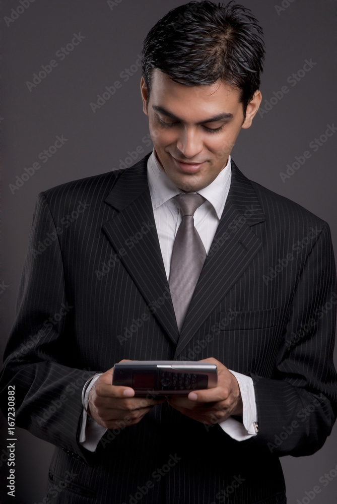 Businessman holding a communicator Businessman holding a communicator