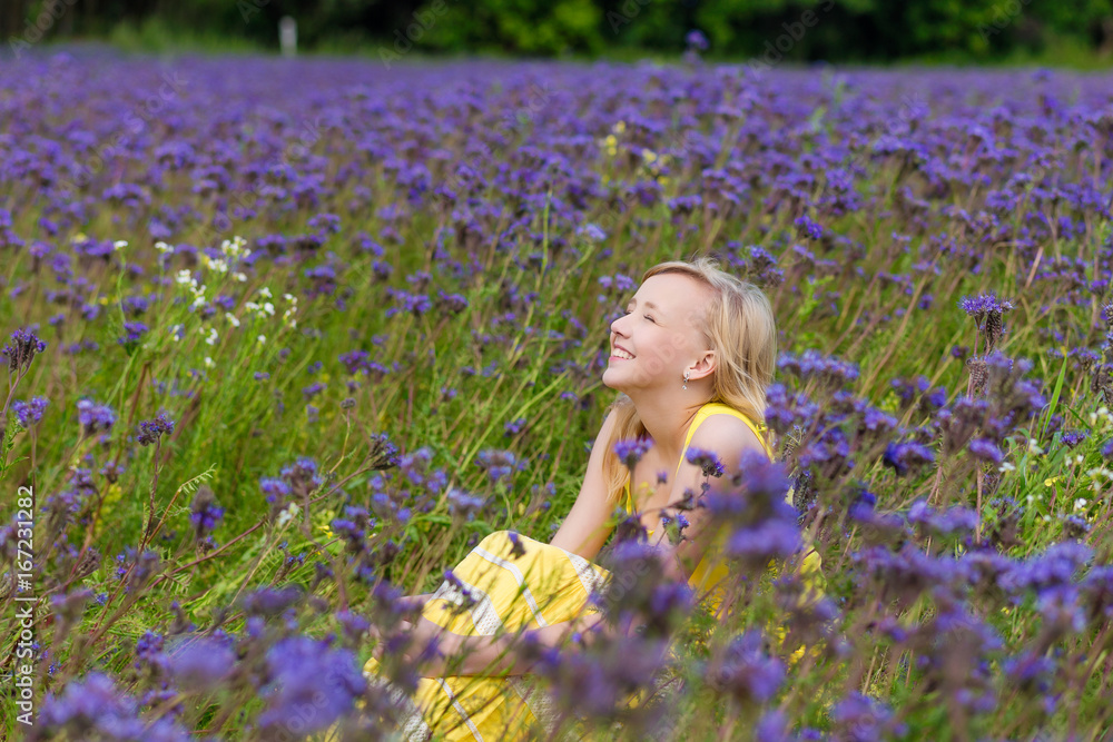 Girl in purple flowers outdoors in summer Girl in purple flowers outdoors in summer