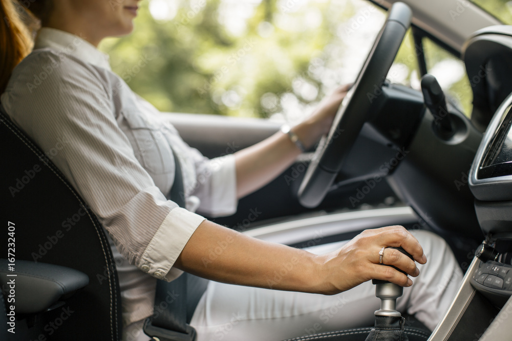 Businesswoman driving car, partial view Businesswoman driving car, partial view