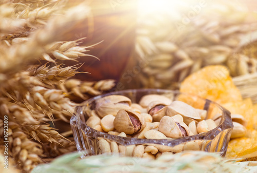 Pistachio nuts, peanuts and potato chips for beer photo