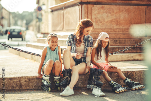 Photography Mother plays with her daughters on the street in neighborhood