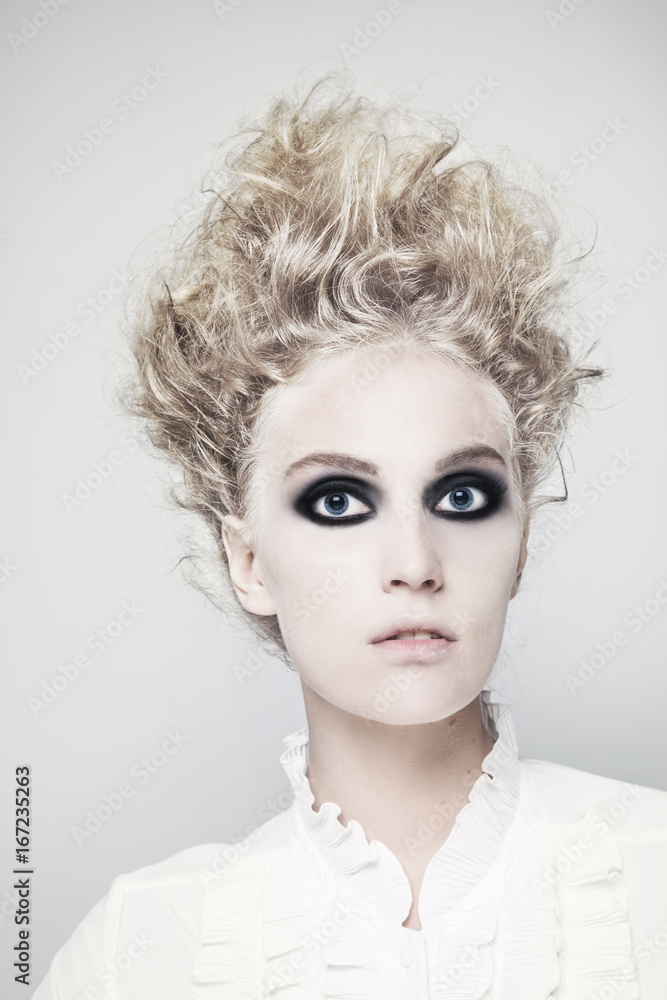 Woman with crazy victorian hair style and pale skin