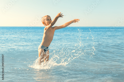 a boy plays in the sea
