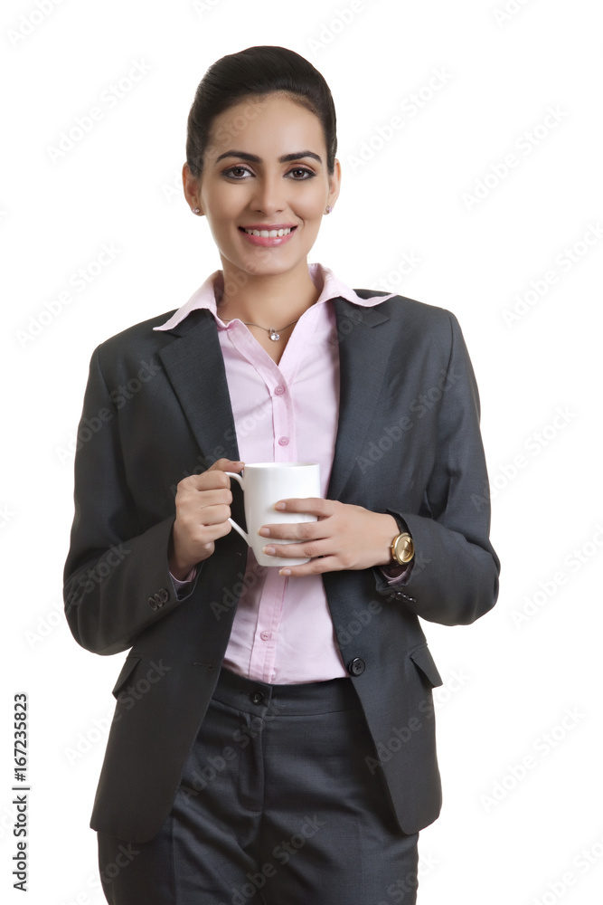 Portrait of young businesswoman holding coffee cup over white background