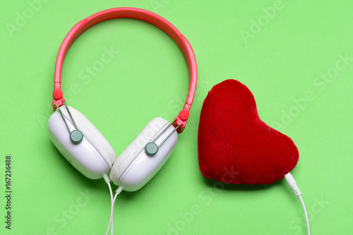 Headphones in white and red color with soft toy heart