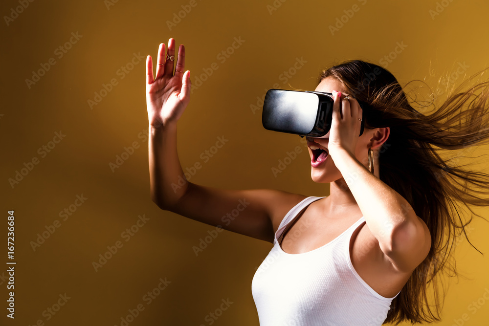 Happy young woman using a virtual reality headset Happy young woman using a virtual reality headset