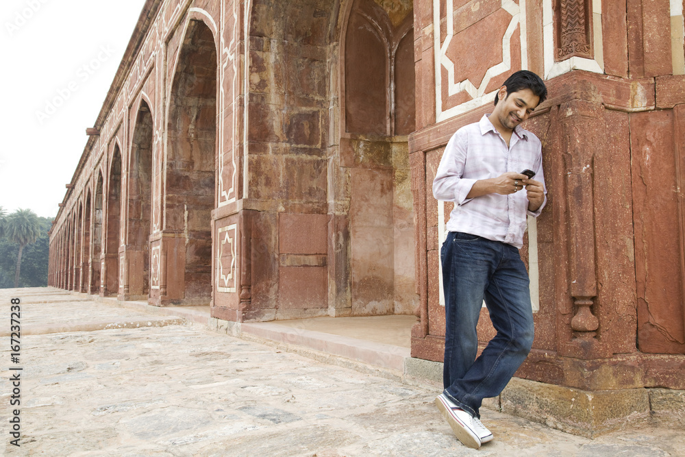 Boy looking at an sms at Humayuns Tomb 
