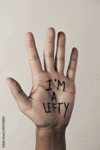 text I am a lefty in the palm of the hand photo