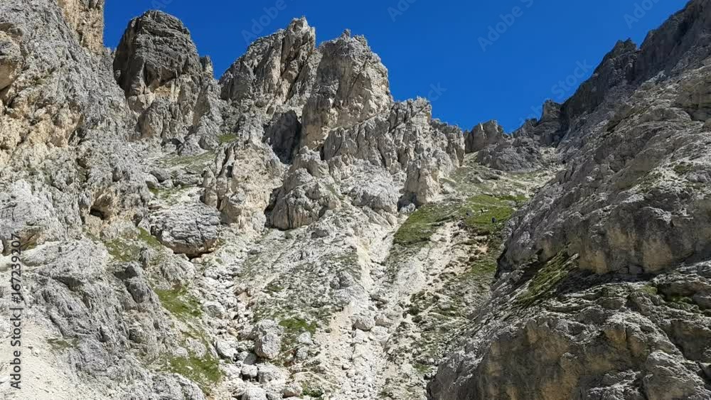 Trekker group walking in a steep path at the foot of Col dei Bos, Dolomites, Cortina d'Ampezzo, Italy Trekker group walking in a steep path at the foot of Col dei Bos, Dolomites, Cortina d'Ampezzo, Italy