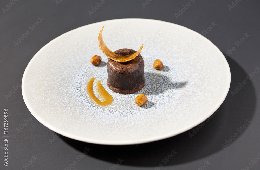 chocolate fondant with caramel on textured plate Stock Photo | Adobe Stock