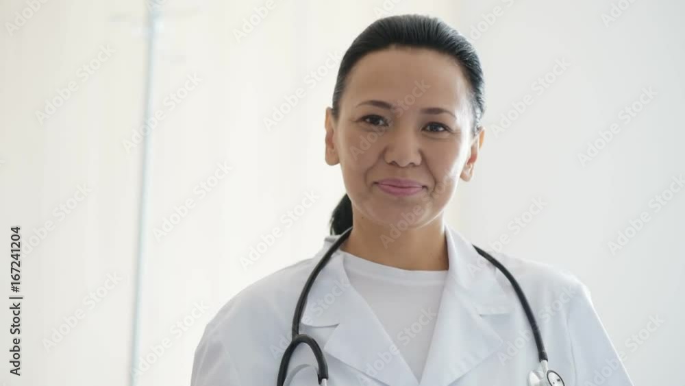 Cheerful woman with stethoscope on the neck working in the clinic Cheerful woman with stethoscope on the neck working in the clinic